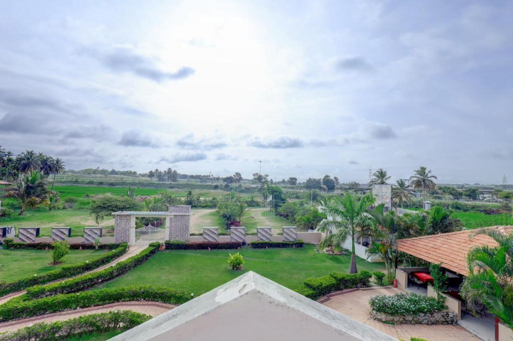 an aerial view of a resort with chairs and a garden at Royal Garden Brindavan Resort in Hosa Kannambādi