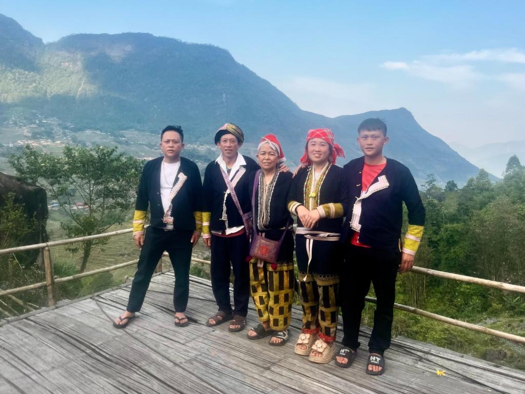a group of people posing for a picture on a bridge at Mama Pham Homestay in Tả Van