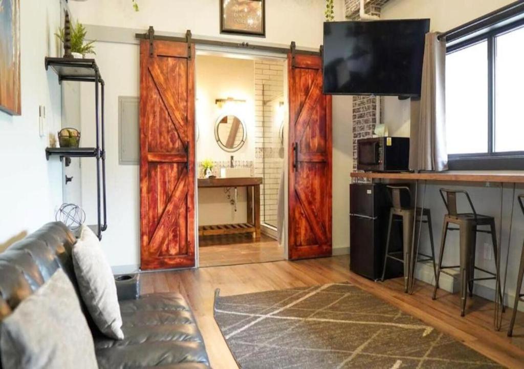 a living room with wooden doors and a bar at Rivers Edge Lofts - Unit 5 in Niles