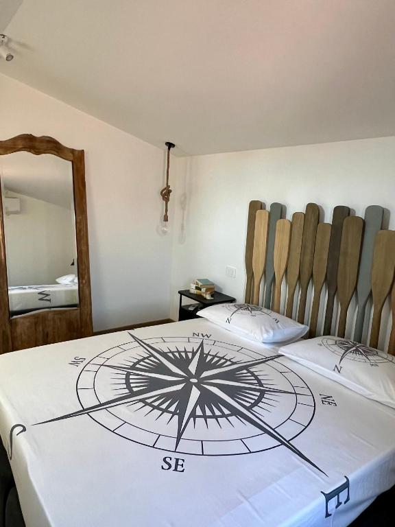 a room with two beds with a clock on it at Casa PIVA 781 in Chioggia