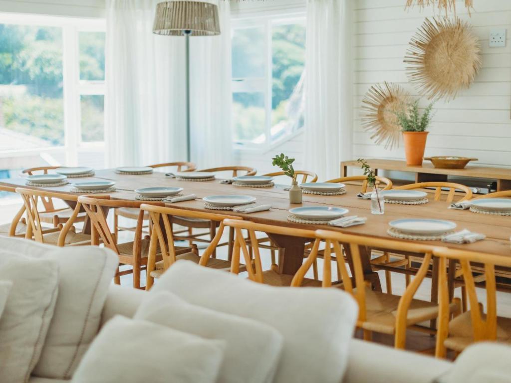 a dining room with a wooden table and chairs at Sun and Sea Glentana in Glentana