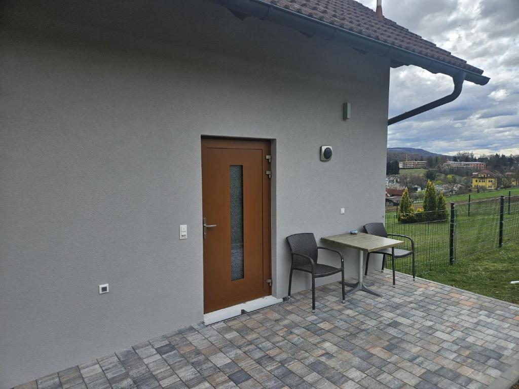 a patio with a door and a table and chairs at Ferienwohnung 2 am Gleichenberger "Kogl" in Bad Gleichenberg
