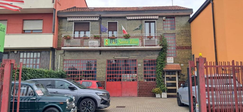 a parking lot with cars parked in front of a building at Bed and Breakfast Santa Elisa in Pero