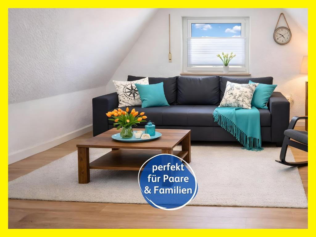a living room with a couch and a coffee table at strandnah & ruhig für 4 Pers in Bensersiel