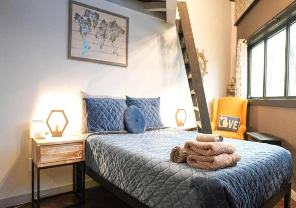 a bedroom with a bed with a blue comforter at Rivers Edge Lofts - Unit 4 in Niles