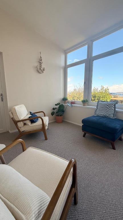 a living room with two beds and a window at Vistamar Dunoon in Dunoon