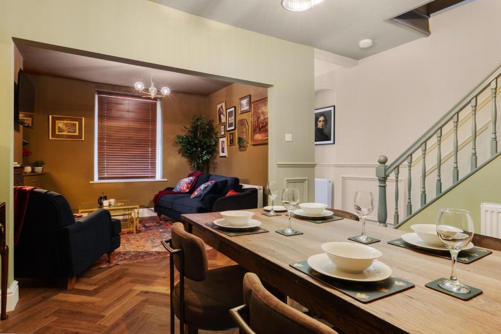 a dining room with a table with wine glasses at Spacious 2 Bed House Lancaster in Lancaster