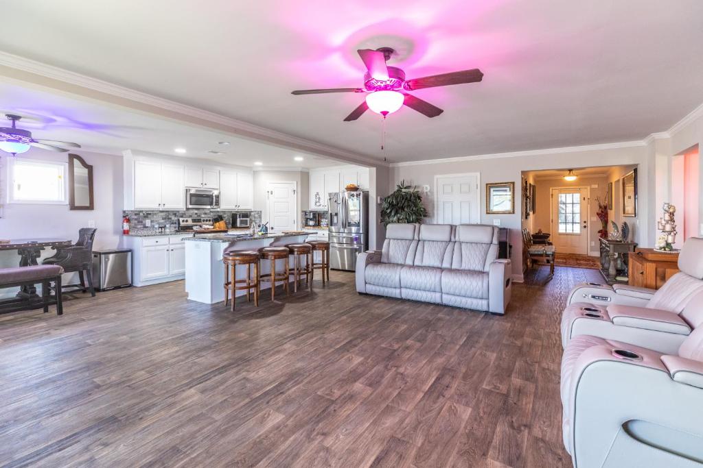 a living room with a couch and a ceiling fan at Hideaway Getaway in Statham