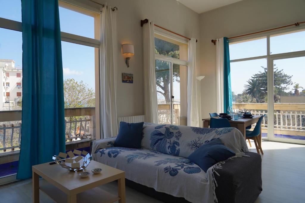 a living room with a couch and a table at Sirene Blu Mondello in Palermo