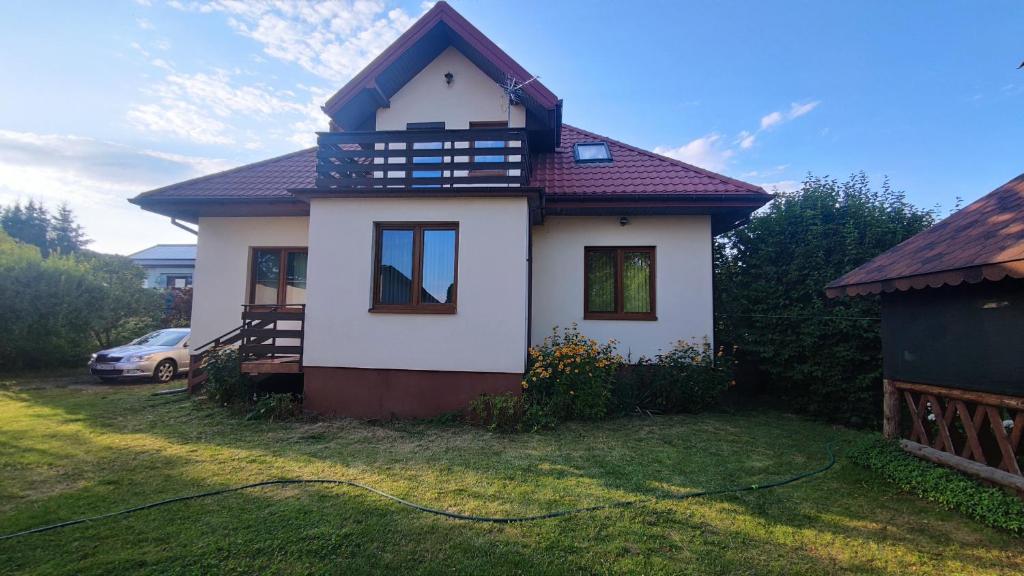 a small house with a roof on a yard at Vikos-Spa in Rzeczyca