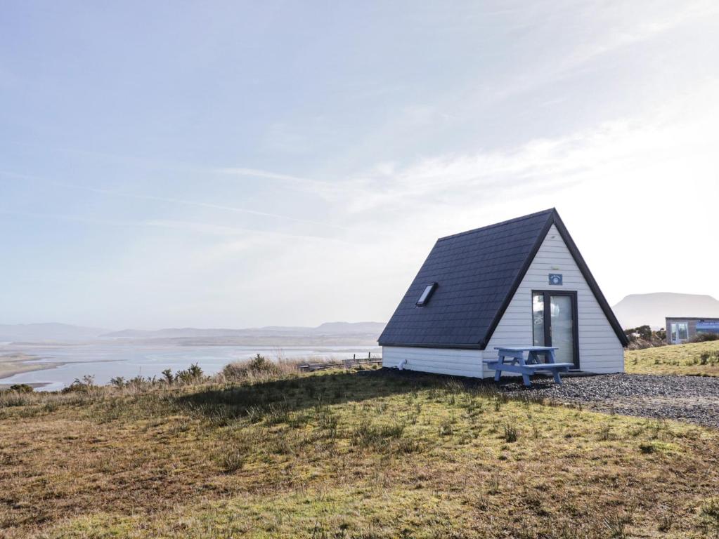 a tiny house on top of a hill at Cabin 10 Inis Bo Finne in Gortahork