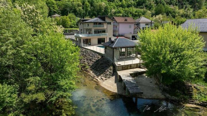 an aerial view of a house next to a river at Villa Boomerang in Srbljani