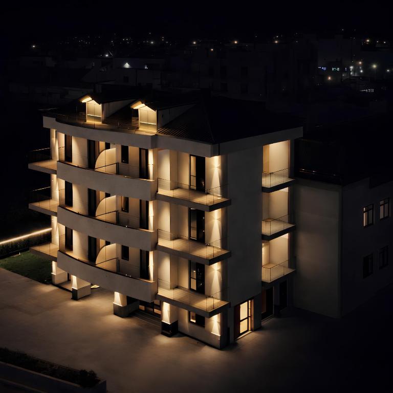 a night view of a building with lights on at TerrAmare Suites in Baronissi
