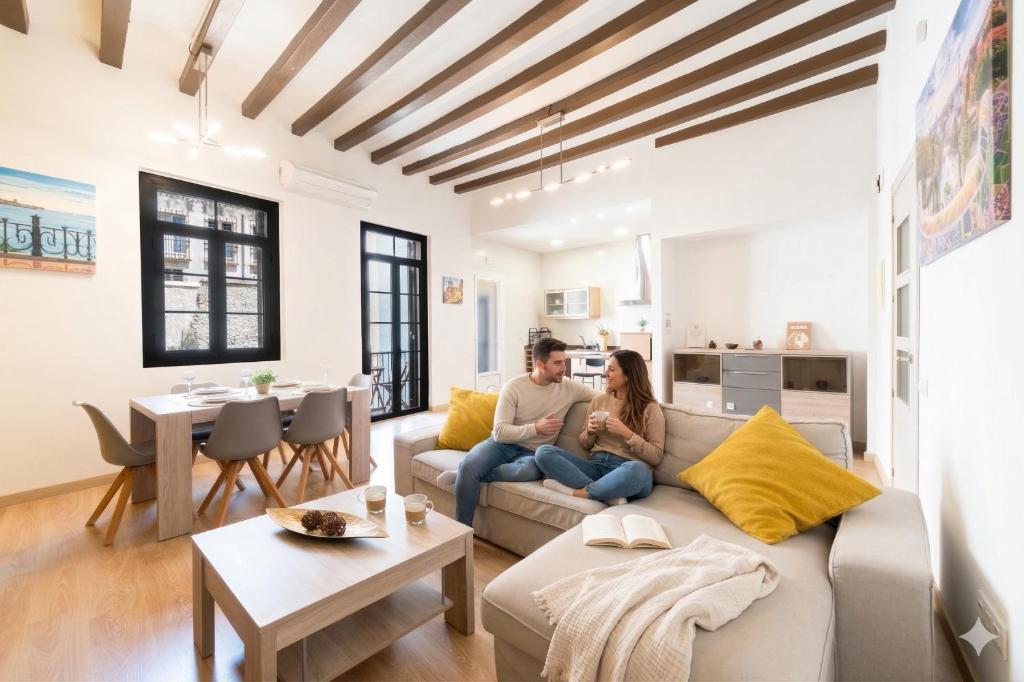 a man and woman sitting on a couch in a living room at weroomies - Sant Domenec in Tarragona