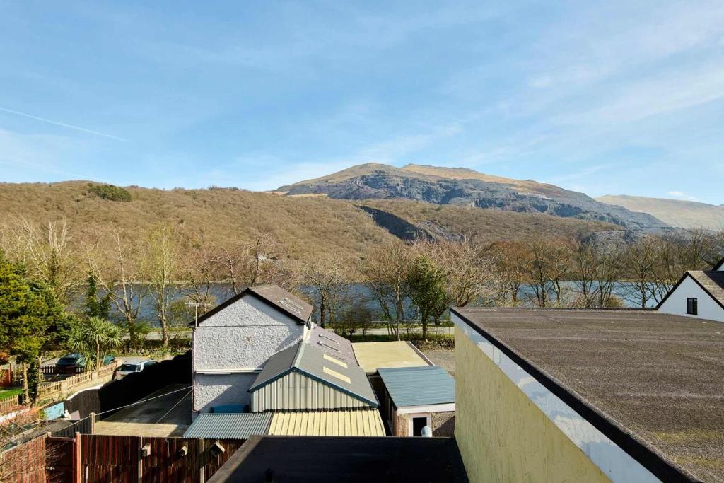 an aerial view of a house with mountains in the background at Host & Stay - Llanberis Flat in Llanberis