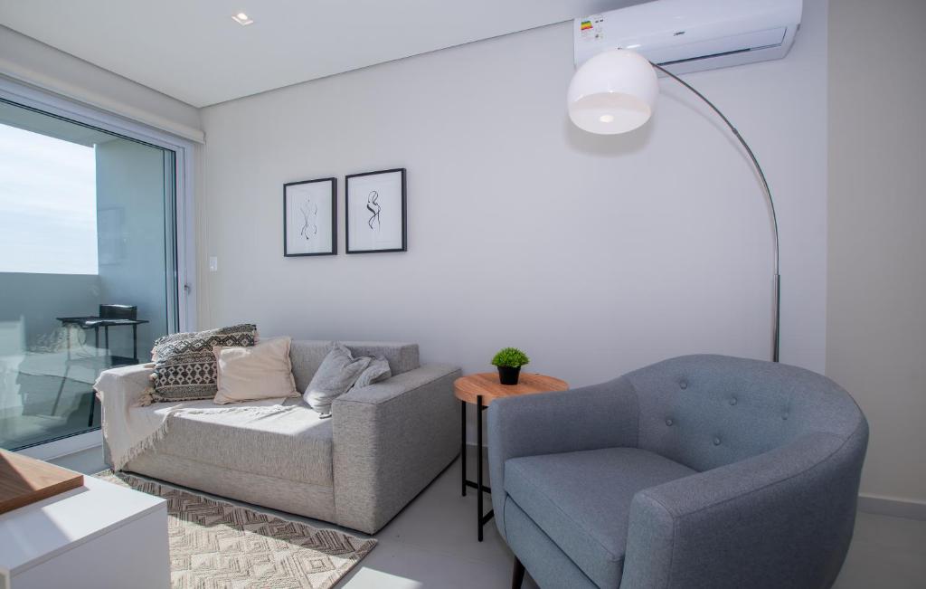 a living room with a couch and a chair at Cityscape Views - New 2BR Retreat in Asunción