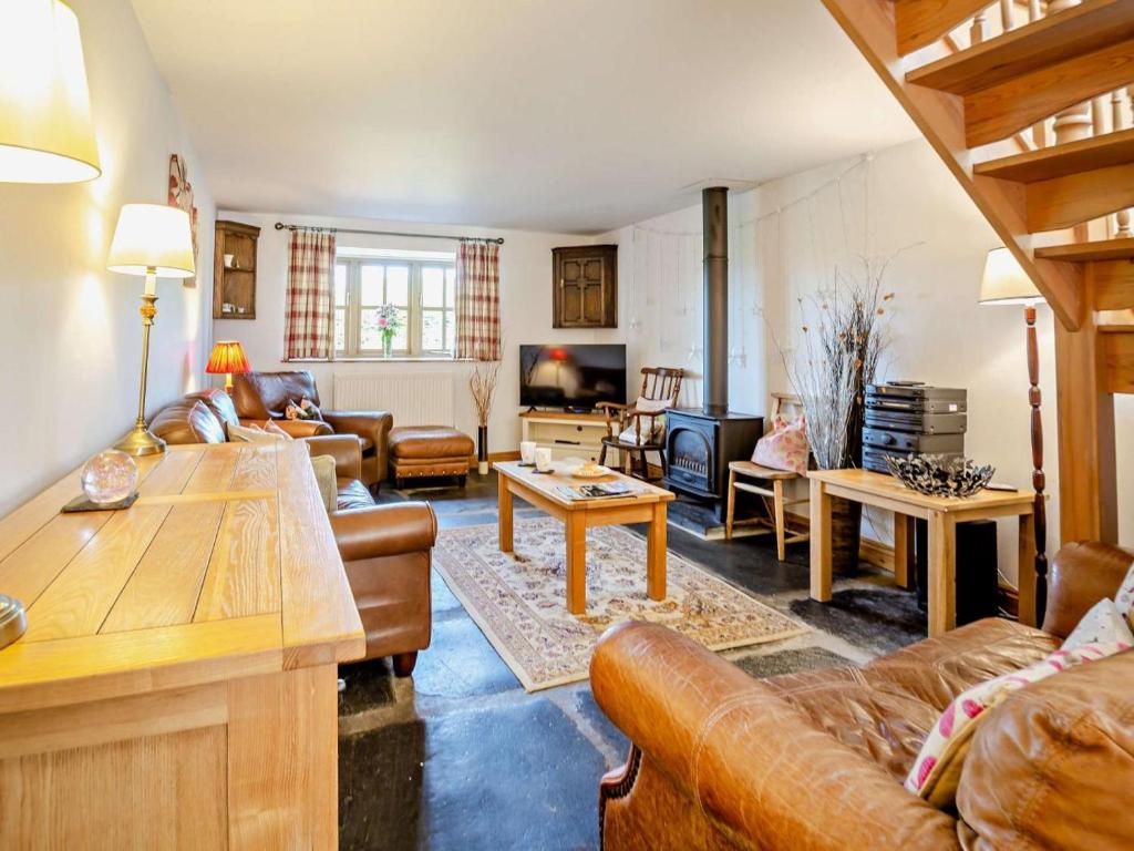 a living room with a couch and a table at 3 Bed in Tywyn oc-dy021 in Tywyn