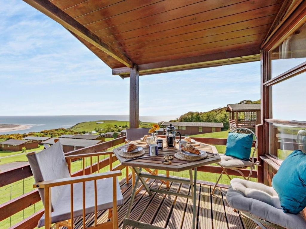 a patio with a table and chairs and the ocean at 2 Bed in Aberdyfi oc-dy050 in Aberdyfi
