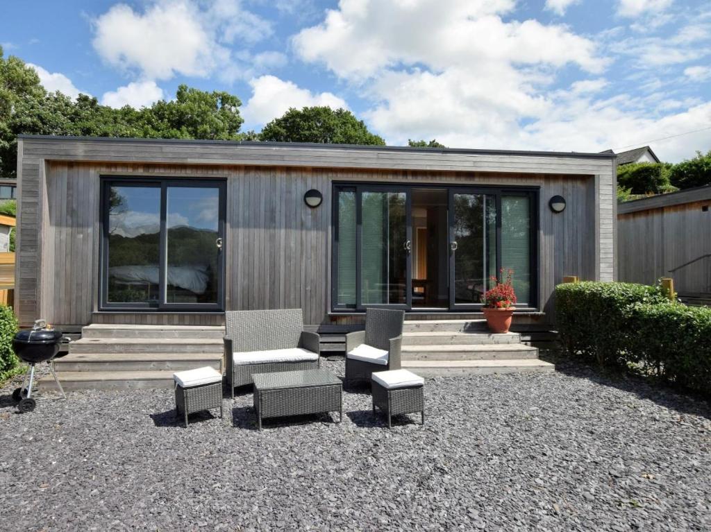 a small house with a group of chairs and windows at 1 Bed in Conwy oc-60294 in Llangelynin