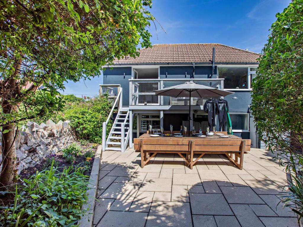 a patio with a table and an umbrella at 4 Bed in Braunton oc-56111 in Croyde
