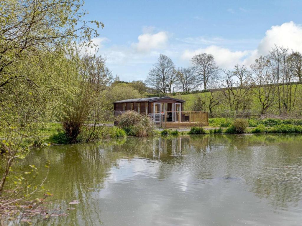 a house sitting on the side of a lake at 2 Bed in South Brent oc-82871 in South Brent