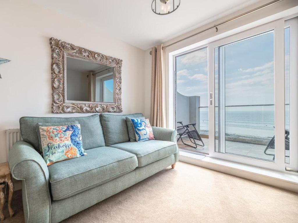 a living room with a couch and a large window at 2 Bed in Tywyn oc-dy052 in Tywyn