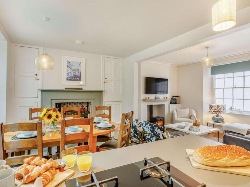 a living room with a table and a dining room at 4 Bed in Bideford oc-88876 in Appledore