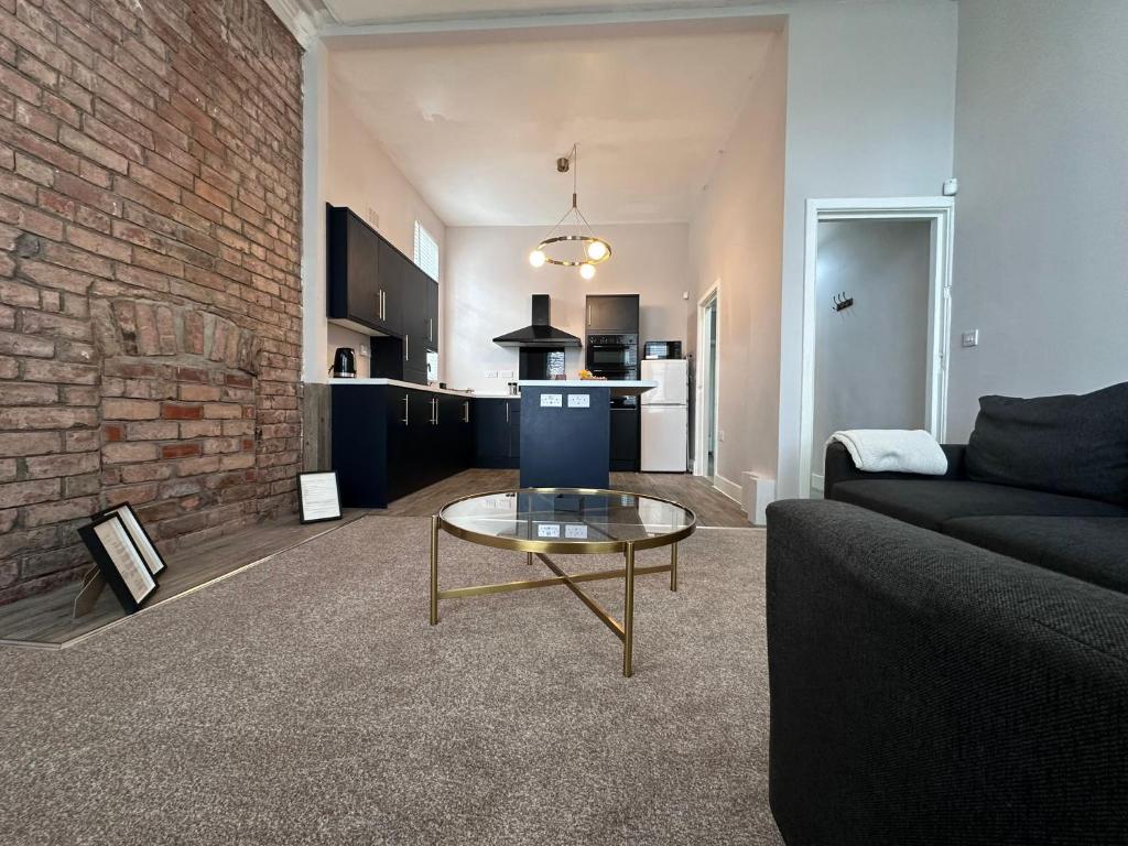 a living room with a couch and a table at Spacious Victorian Apt Sleeps 5 Parking available in Nottingham