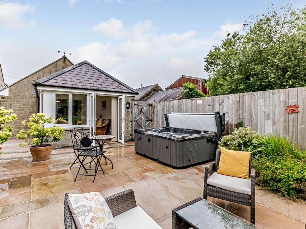 a patio with a barbecue grill in a backyard at 1 Bed in Kilgetty oc-59667 in Yerbeston