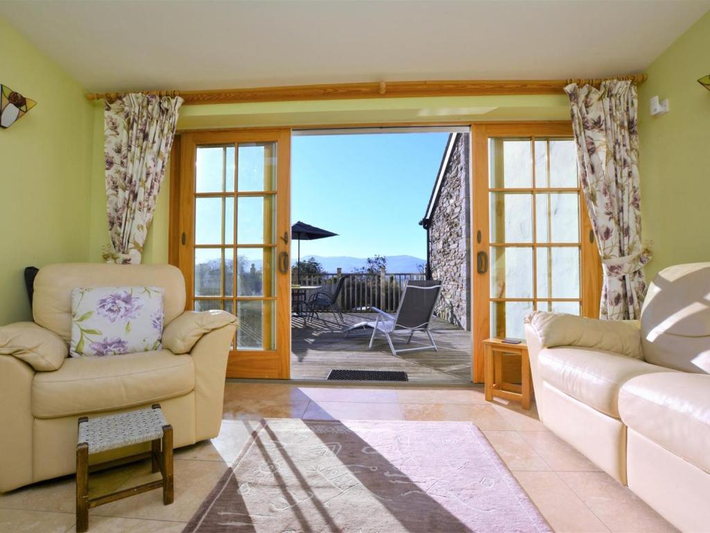 a living room with a couch and a chair at 2 Bed in Colwyn Bay oc-74147 in Eglwys-Fâch