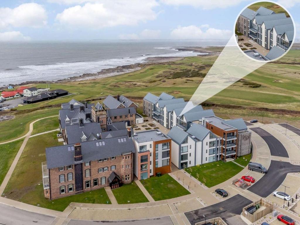 an aerial view of a building next to the ocean at 2 Bed in Porthcawl oc-89696 in Porthcawl