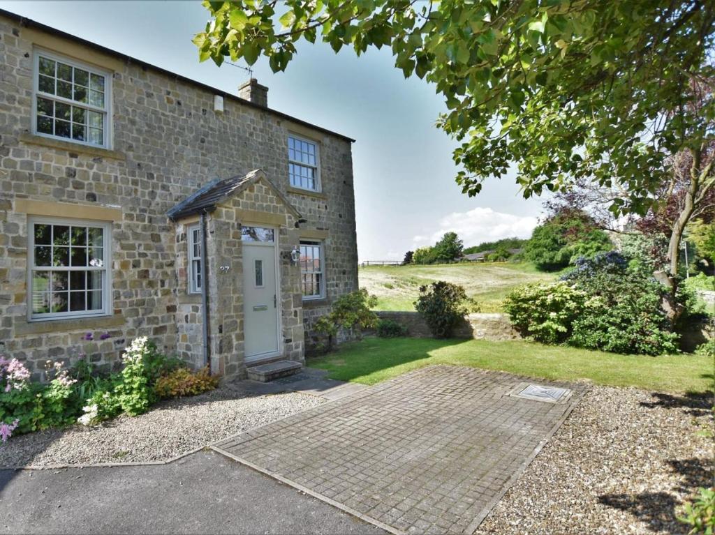 an old stone house with a white door at 3 Bed in Richmond oc-90578 in Catterick Bridge