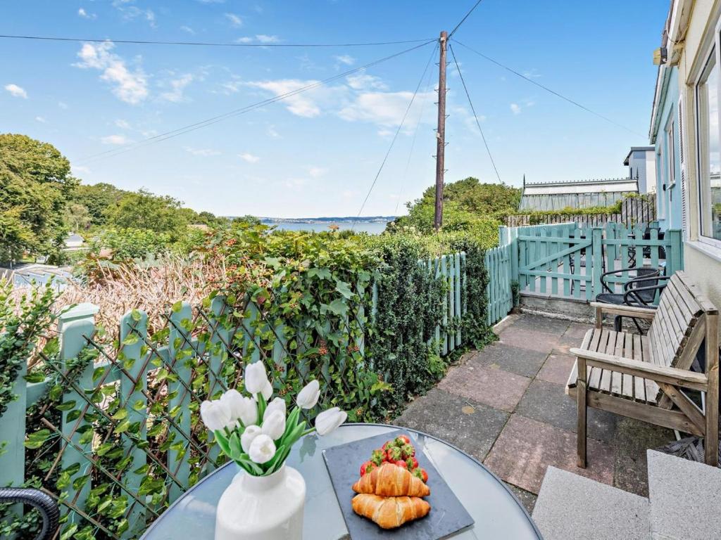 a table with a vase of flowers on a patio at 2 Bed in Brixham oc-bx079 in Brixham
