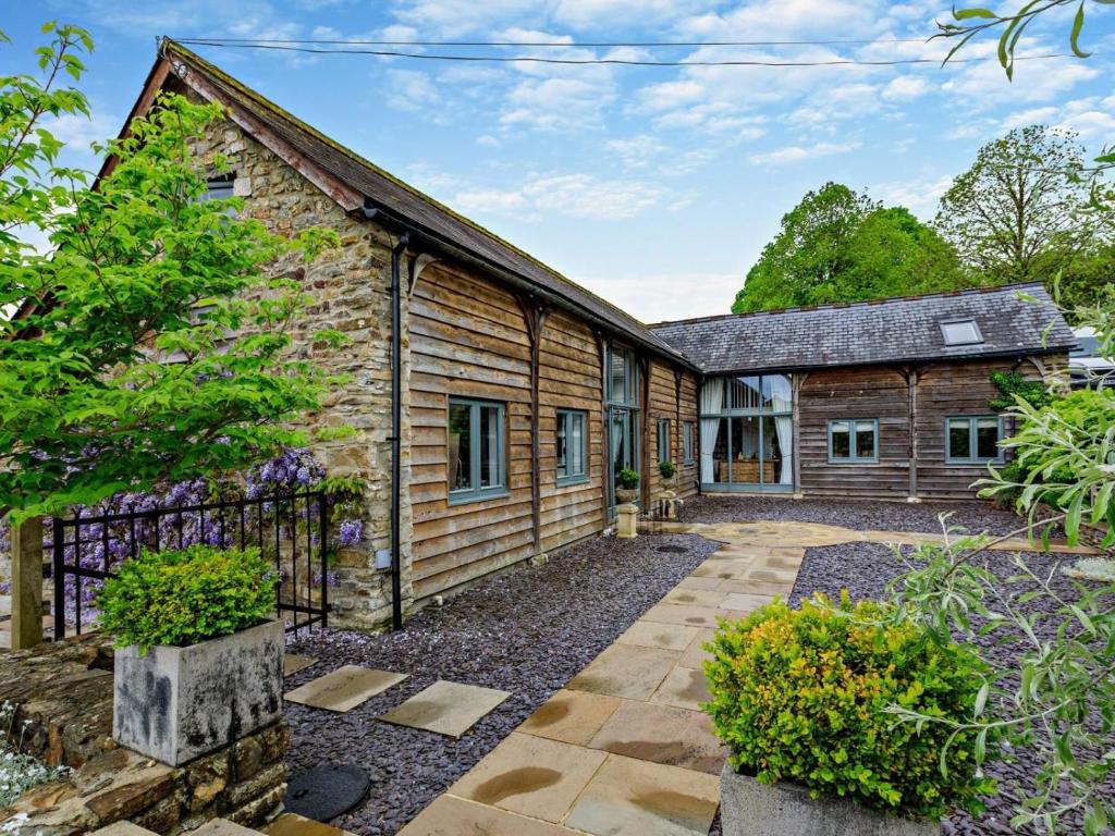 an old stone cottage with a garden in front of it at 5 Bed in Dulverton oc-41133 in Brushford