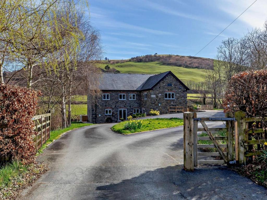 a farm house with a gate on a road at 2 Bed in Llanidloes oc-95815 in Llanidloes
