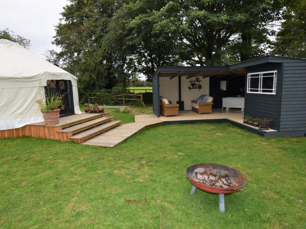 a yurt with a deck and a bench in a yard at 1 Bed in Llandysul oc-85415 in Rhyd Owen