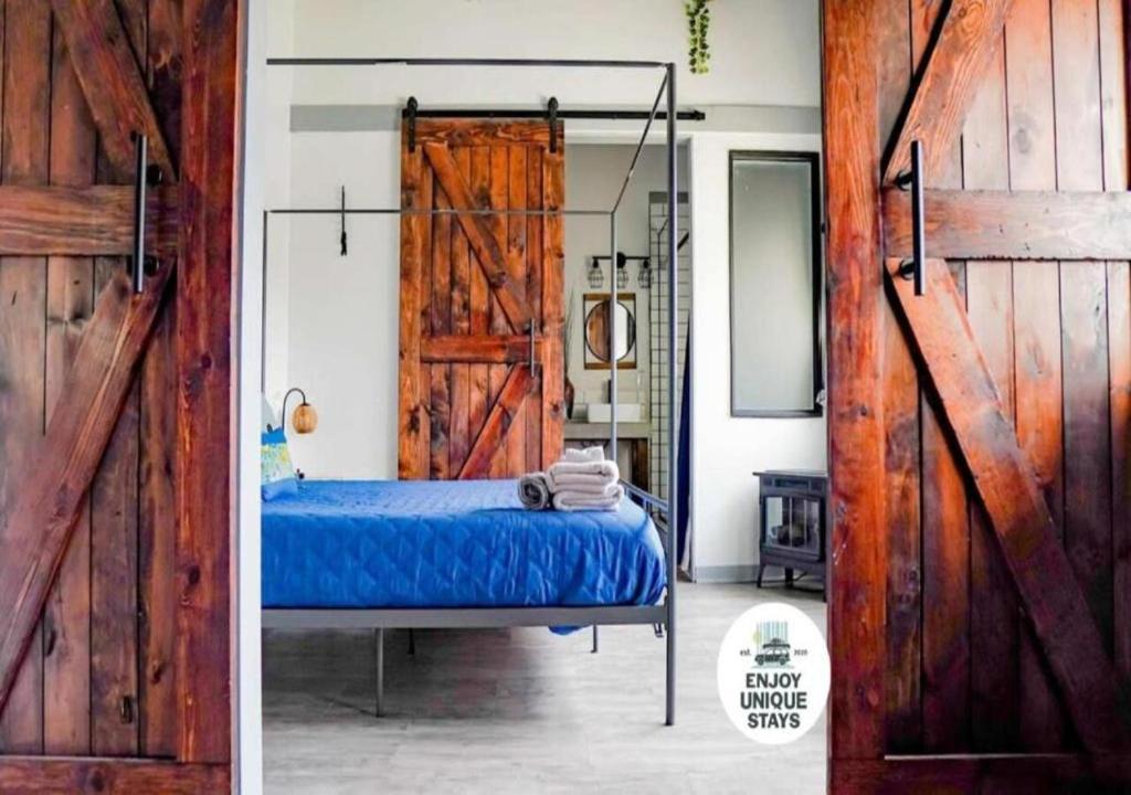 a bedroom with a bed and a sliding barn door at Rivers Edge Lofts - Unit 2 in Niles