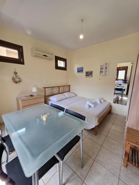 a bedroom with a bed and a table in it at Sea Nest Studio 1 in Agia Ermioni