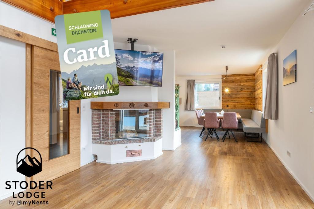 a living room with a fireplace and a sign that reads card at StoderLodge - Alpine Garden Residence - by myNests in Gröbming
