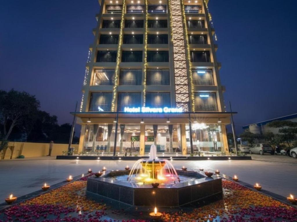 a building with a fountain in front of a building at HOTEL SILVERA GRAND in Ahmedabad