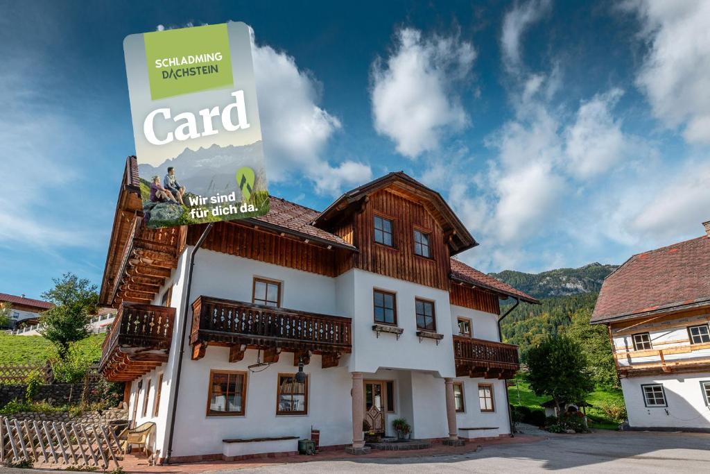 a building with a sign that reads card at BioHAUS - by myNests in Haus im Ennstal