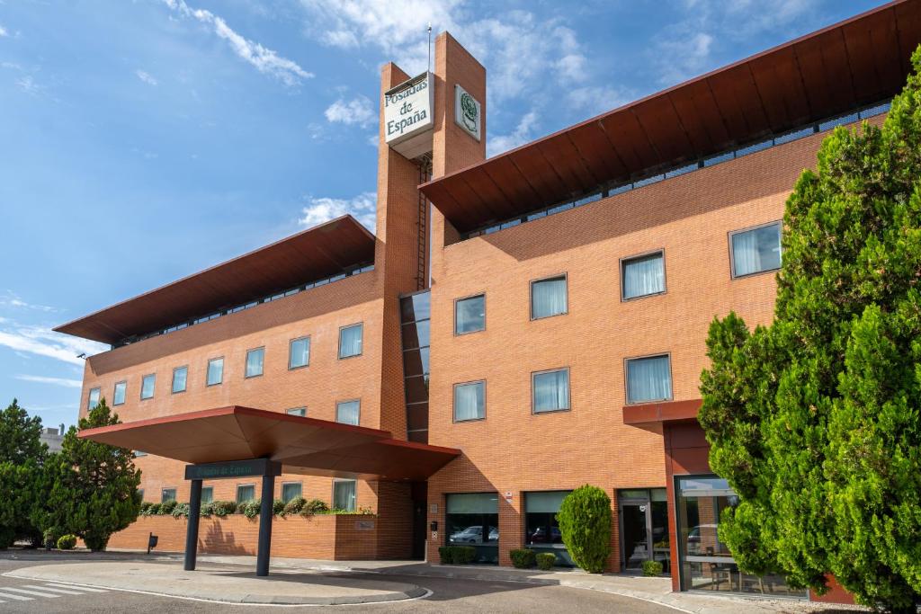 a large brick building with a clock tower at Posadas de España Pinto in Pinto