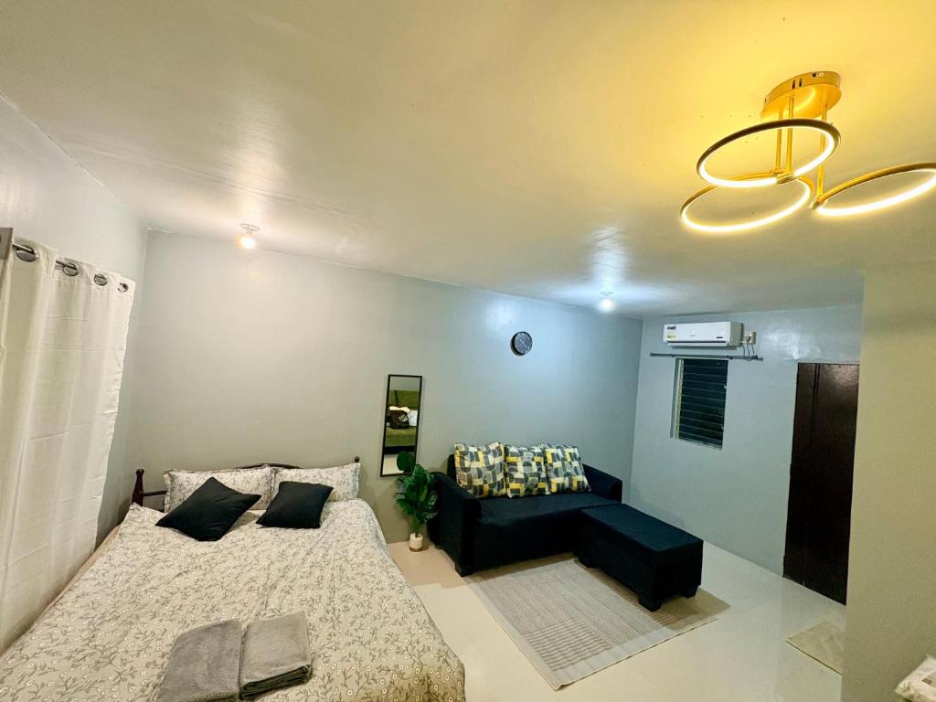 a living room with a bed and a couch at ALCA Homestay in Palo