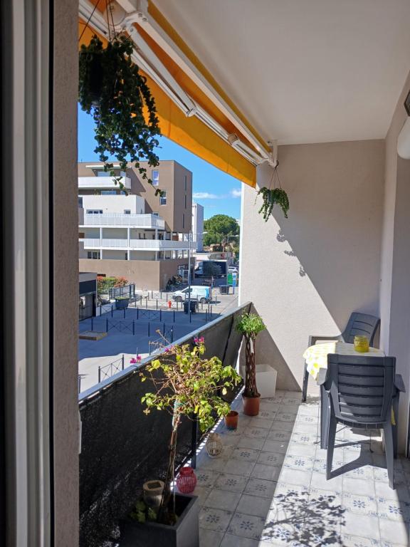 a balcony with plants and a view of a building at Résidence bel azur in Montpellier