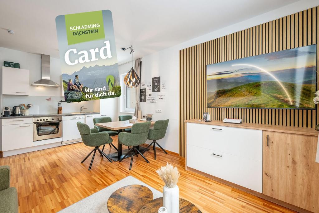 a kitchen with a table and chairs and a large screen at Mountain Soulscape by myNests in Ennsling