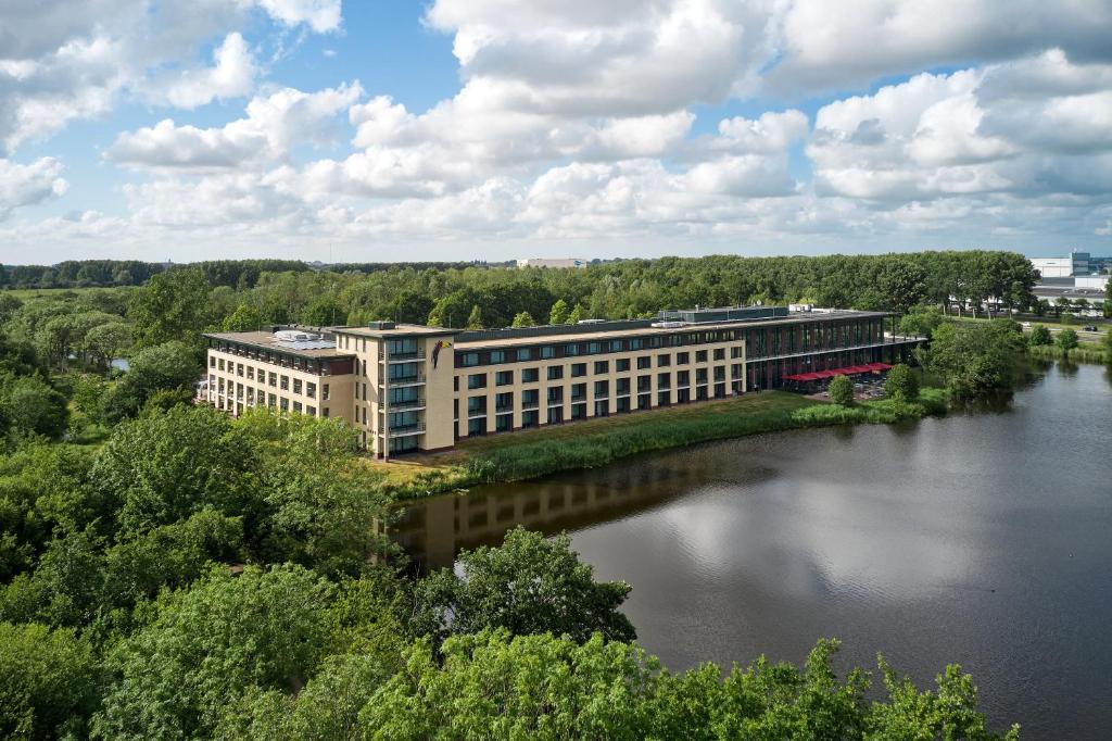 an office building with a bridge over a river at Van der Valk Hotel Sneek in Sneek