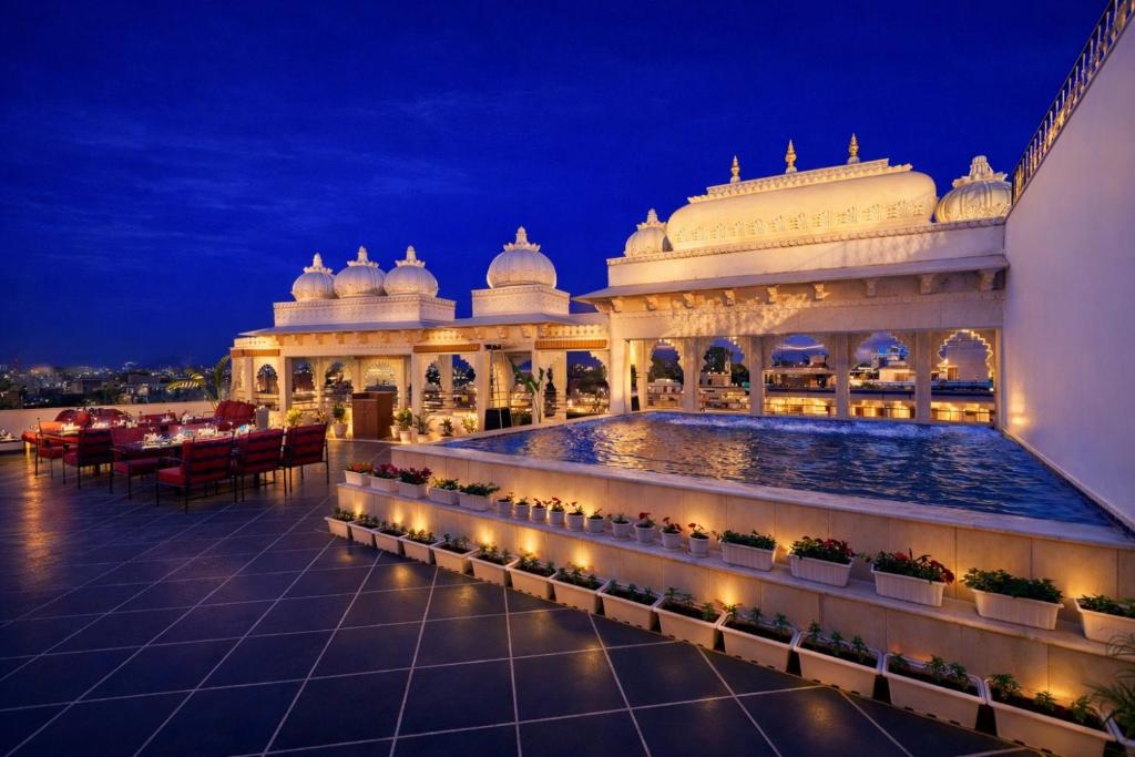 a building with a pool in front of it at night at Chunda Haveli - A Heritage Hotel Near City Palace Udaipur in Udaipur