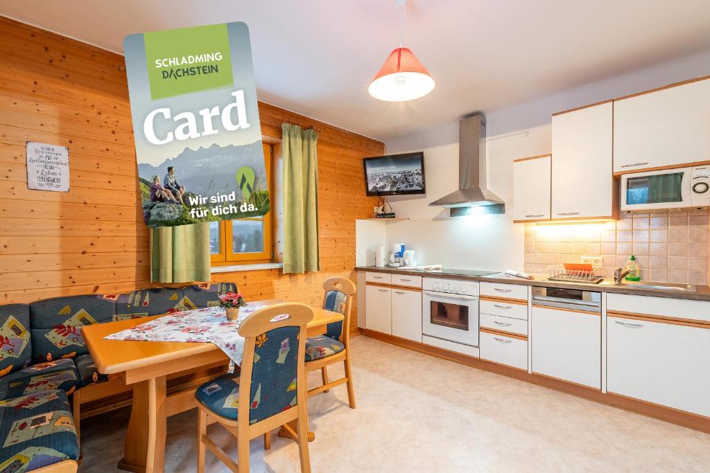 a kitchen and dining room with a table and chairs at Matzling Apartment - by myNests in Mitterberg-Schladming-Dachstein