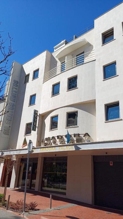 a large white building on a city street at Hotel Amadora Palace in Amadora
