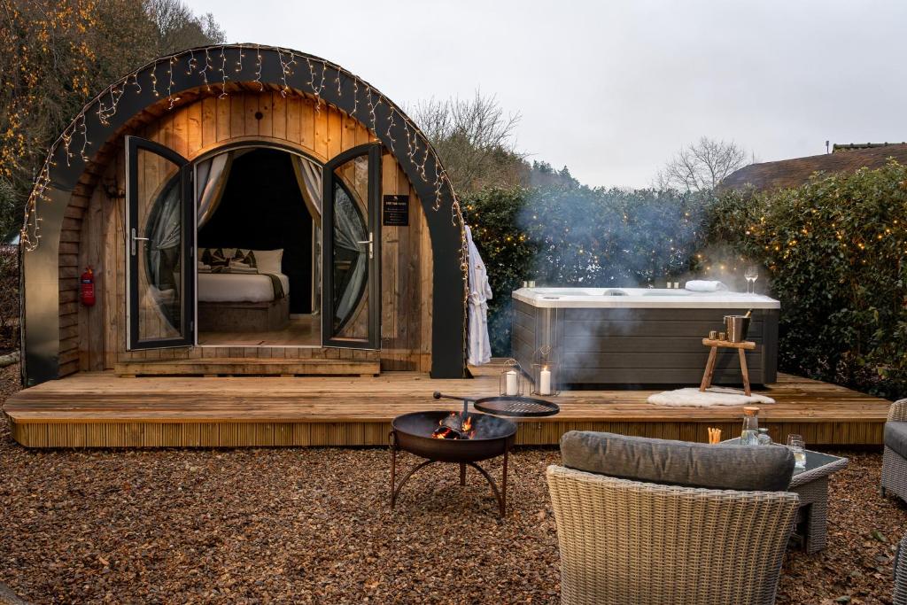 a igloo house with a bed and a table and chairs at Glamping Retreats in Norwich